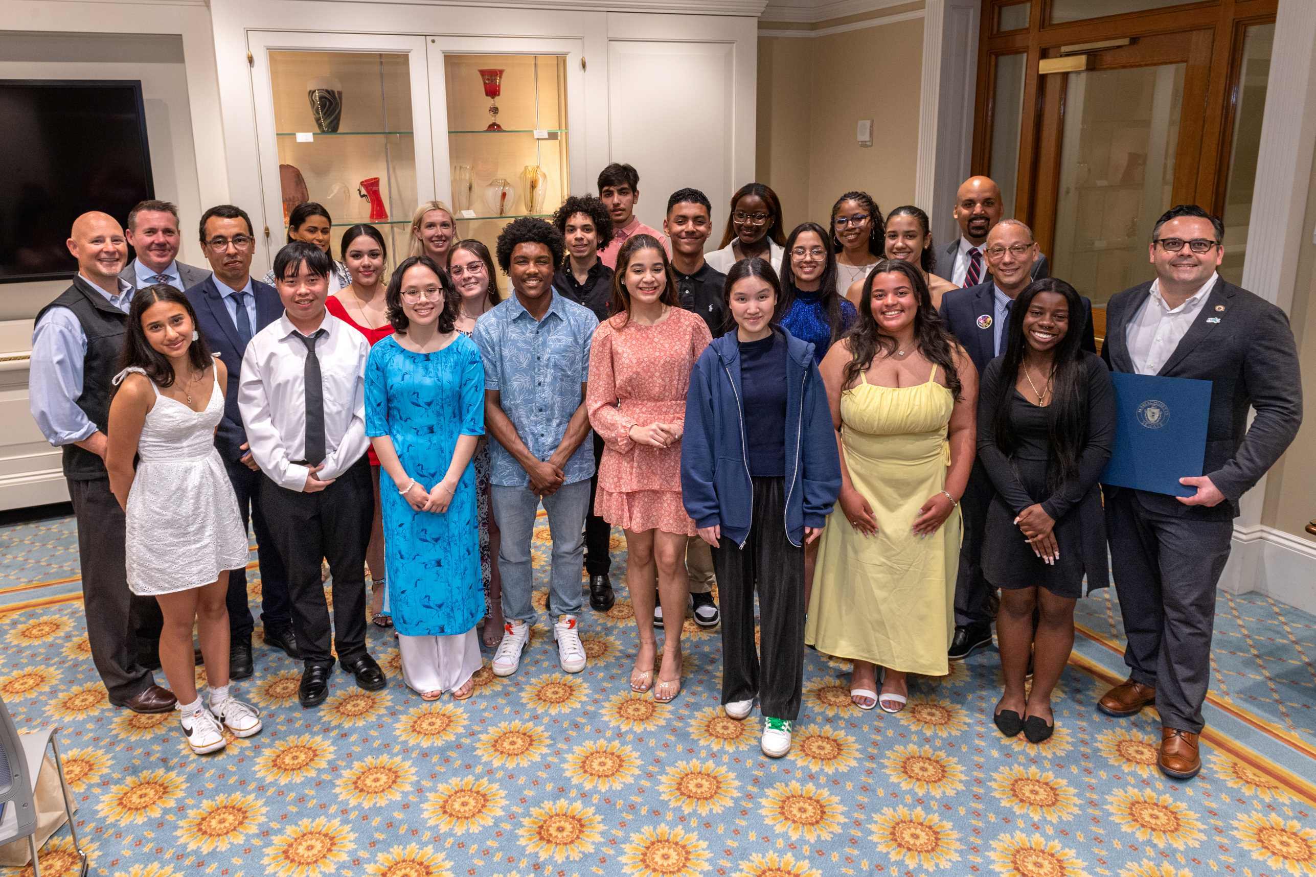 A group of high school students poses with Keolis and state officials