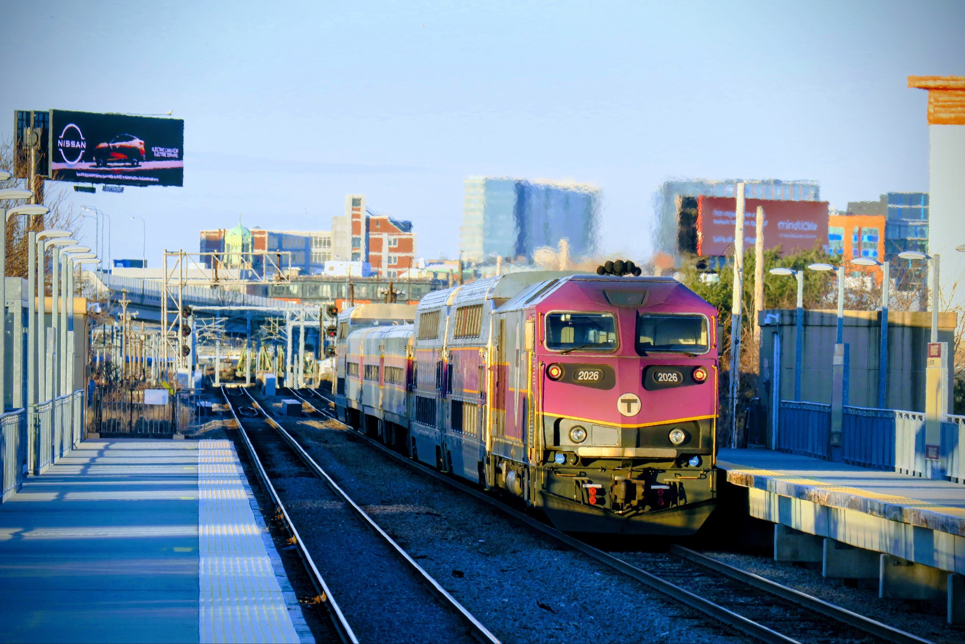 MBTA Commuter Rail train on the Fairmount Line with the City of Boston in the background.